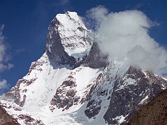 27 Muztagh Tower From Baltoro Glacier On Trek From Goro II to Concordia Taken from the upper Baltoro Glacier, the twin summits of Muztagh Tower (7274m) are perfectly aligned and the mountain is seen as a slender tooth, looking impregnable.  A similar photo by Vittorio Sella in 1909 inspired two expeditions to race for the first ascent in 1956. In reality both teams found their routes less steep than Sella's view had suggested. Joe Brown and Ian McNaught-Davis climbed from the west side of the peak and reached the west summit of Muztagh Tower (7270m) on July 6, 1956.  Tom Patey and John Hartog repeated the ascent the next day, also reaching the slightly higher east summit (7274m). A few days later a French Team of Guido Magnone, Robert Paragot, Andr Contamine, and Paul Keller climbed the mountain from the east.